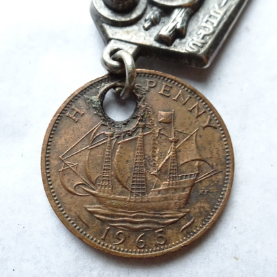 Coin attached to Saint Christopher charm